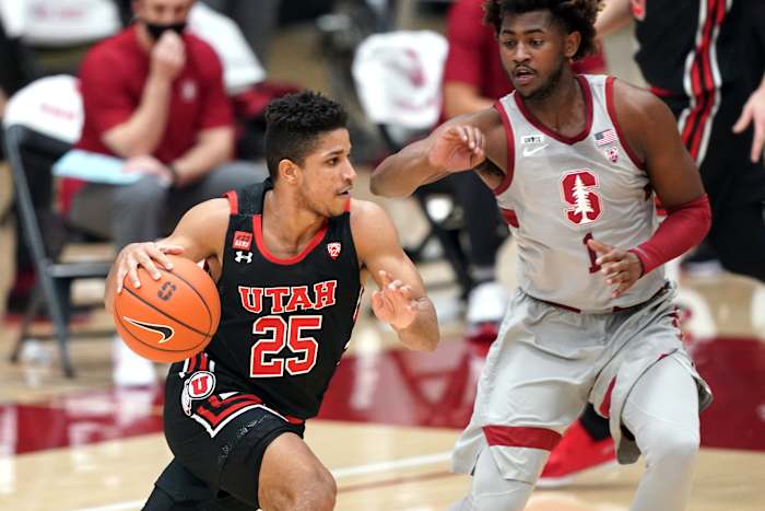Utah Utes guard Alfonso Plummer (25) drives with the ball defended by Stanford Cardinal guard Daejon Davis (1) during the first half of a 2021 game at Maples Pavilion.